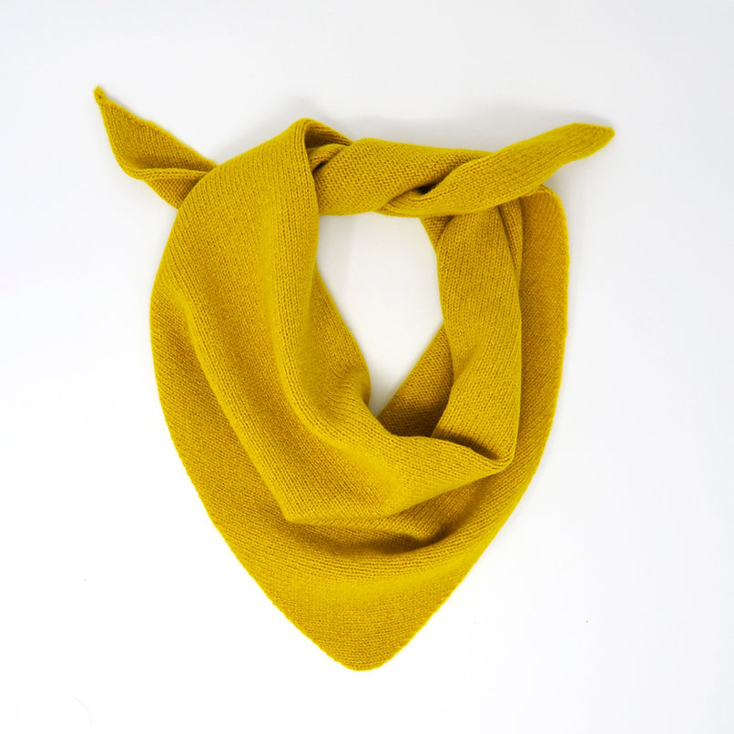Mustard yellow knitted triangular scarf.