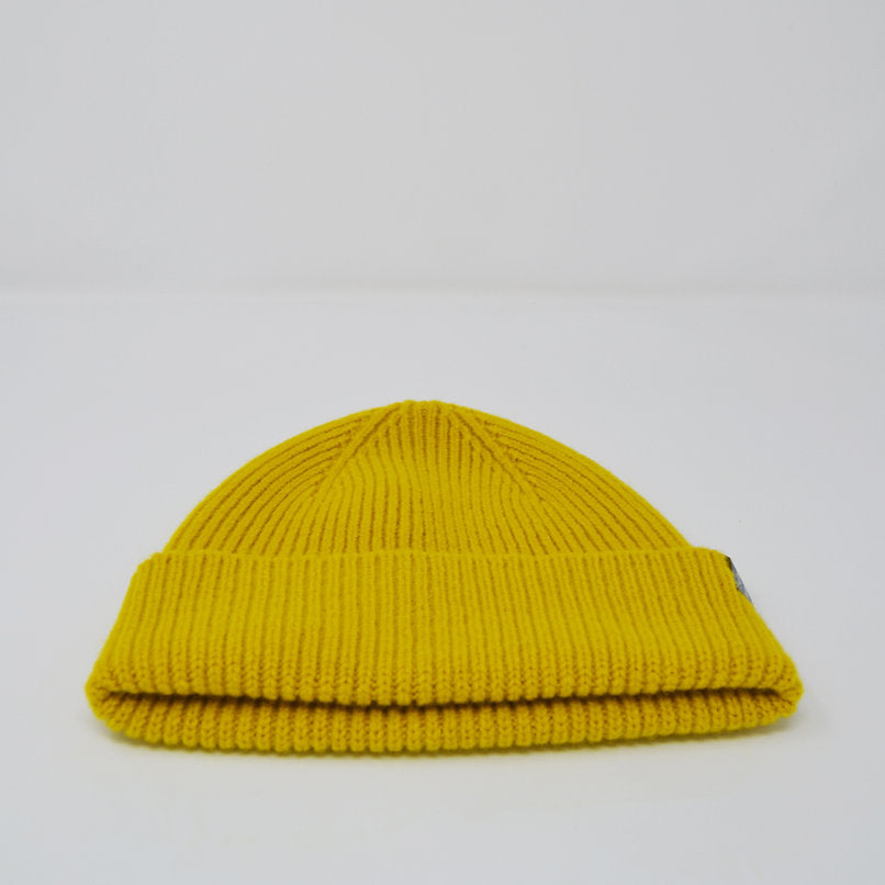 Mustard yellow ribbed knit beanie.