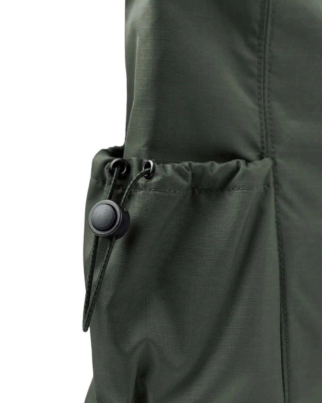 Close-up of a dark olive green drawstring bag pocket with a black toggle.