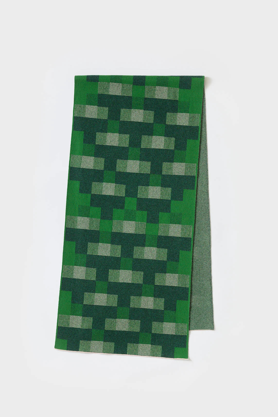 Green knitted scarf with an abstract geometric pattern of dark and light green rectangles.