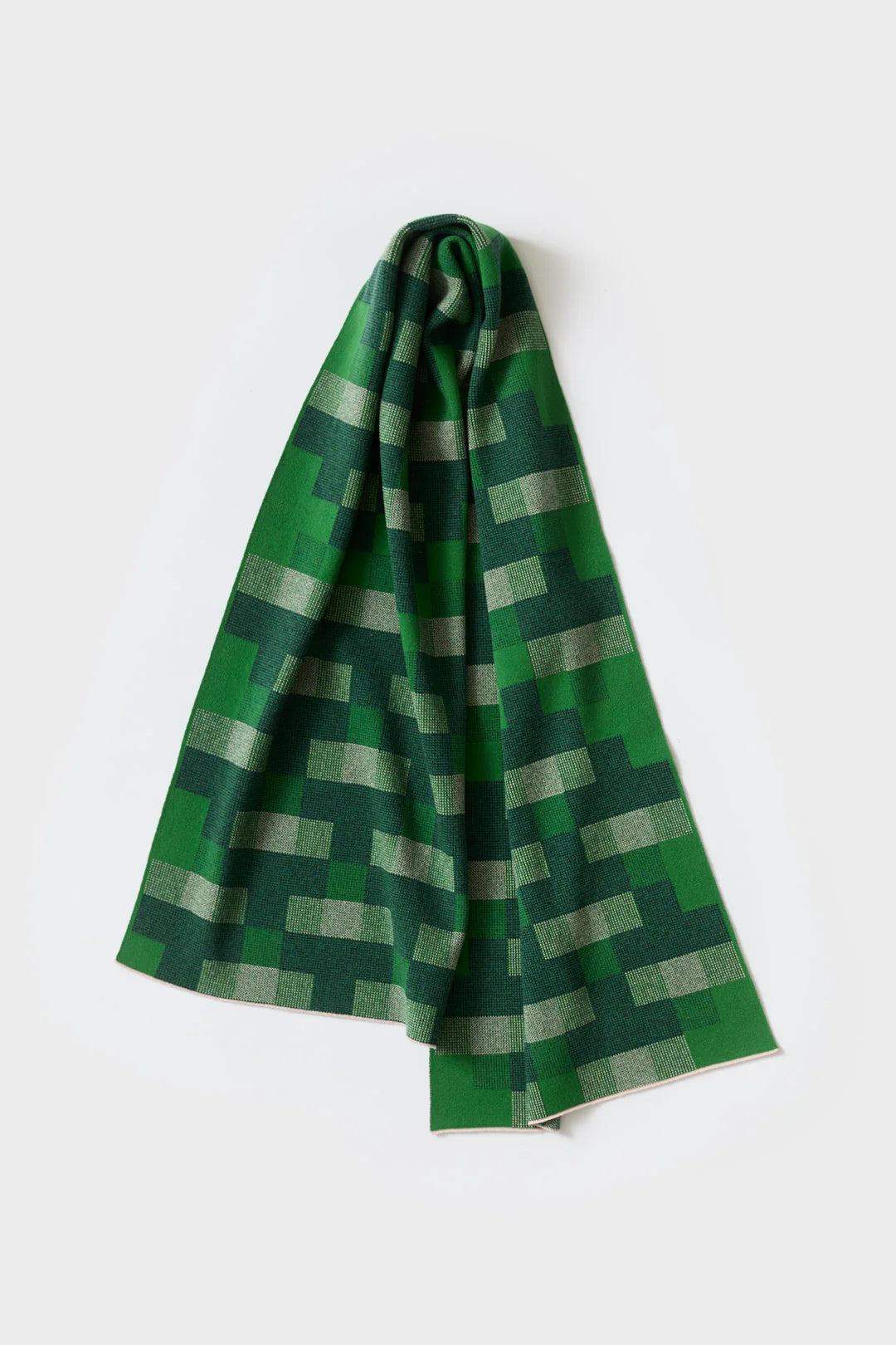 Green knitted scarf with a geometric pattern of dark and light green squares.