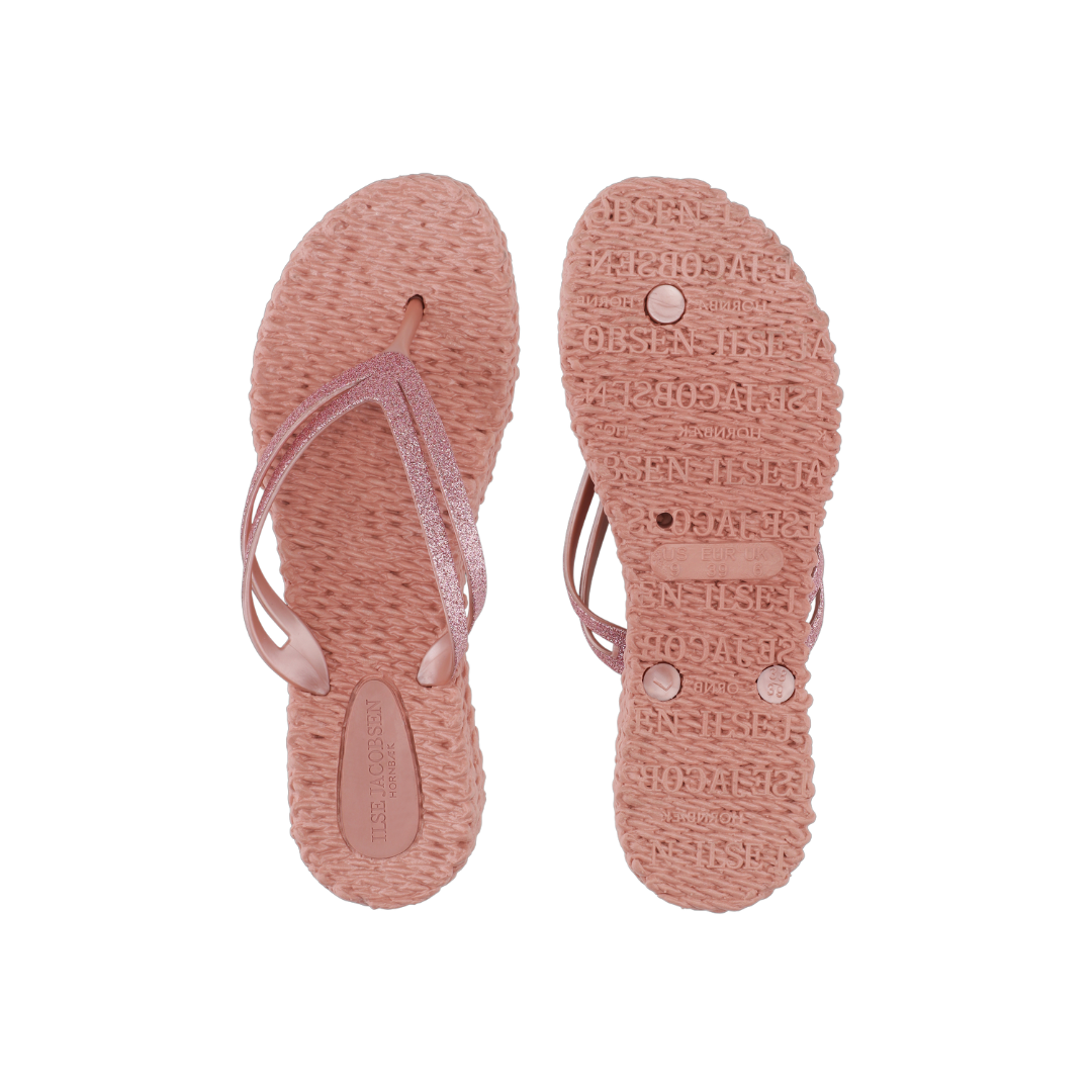 Pair of Ilse Jacobsen Hornbæk rose gold glitter flip-flops; textured soles, sparkly straps.