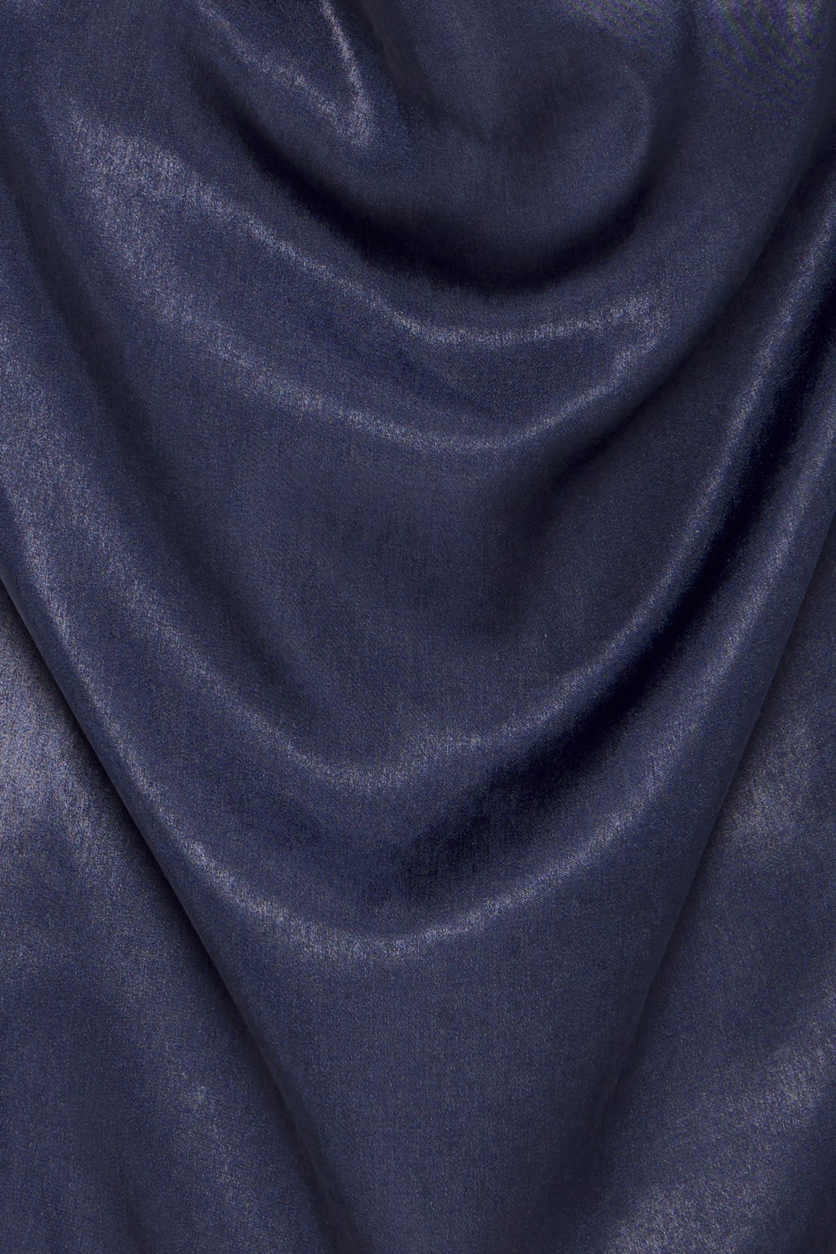 Close-up of dark blue satin fabric with soft, draped folds.