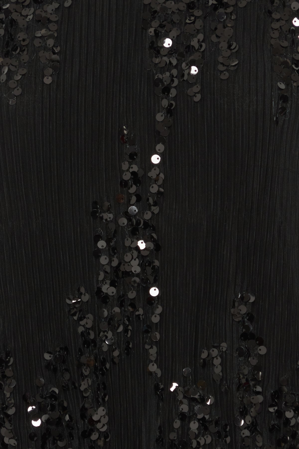 Black pleated fabric adorned with sequined floral patterns.