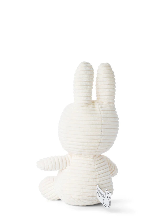 Cream-colored corduroy Miffy plush toy, viewed from behind.