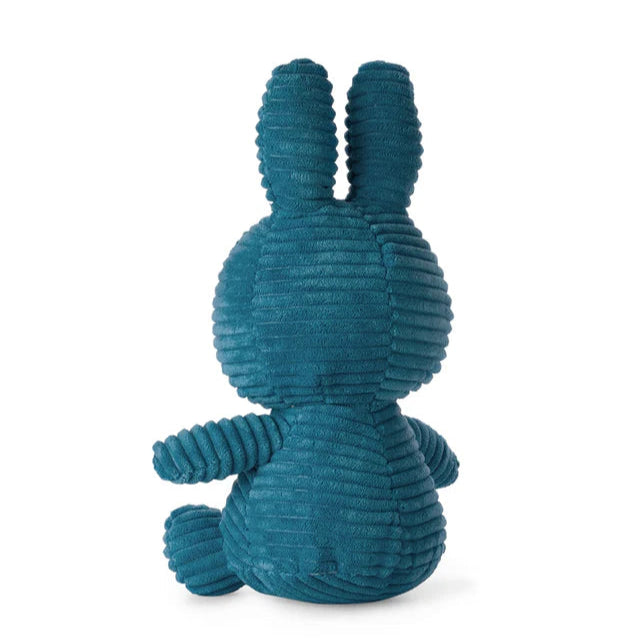 Teal corduroy bunny plush toy sitting down, viewed from behind.