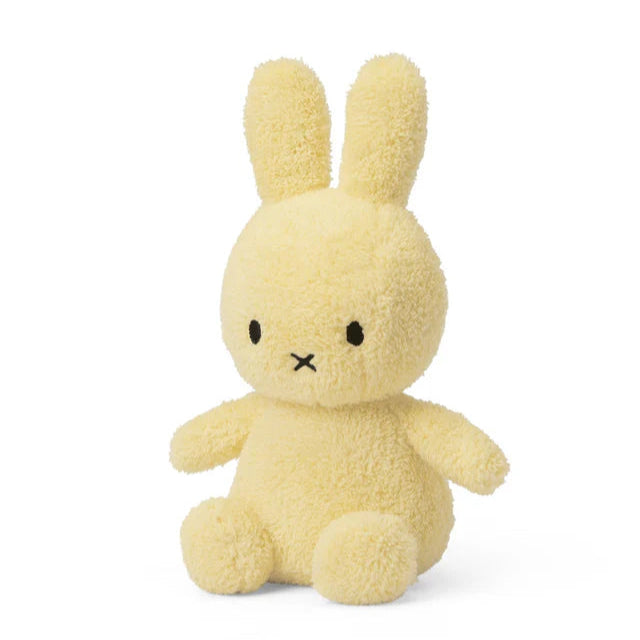 Yellow plush bunny toy on a white background