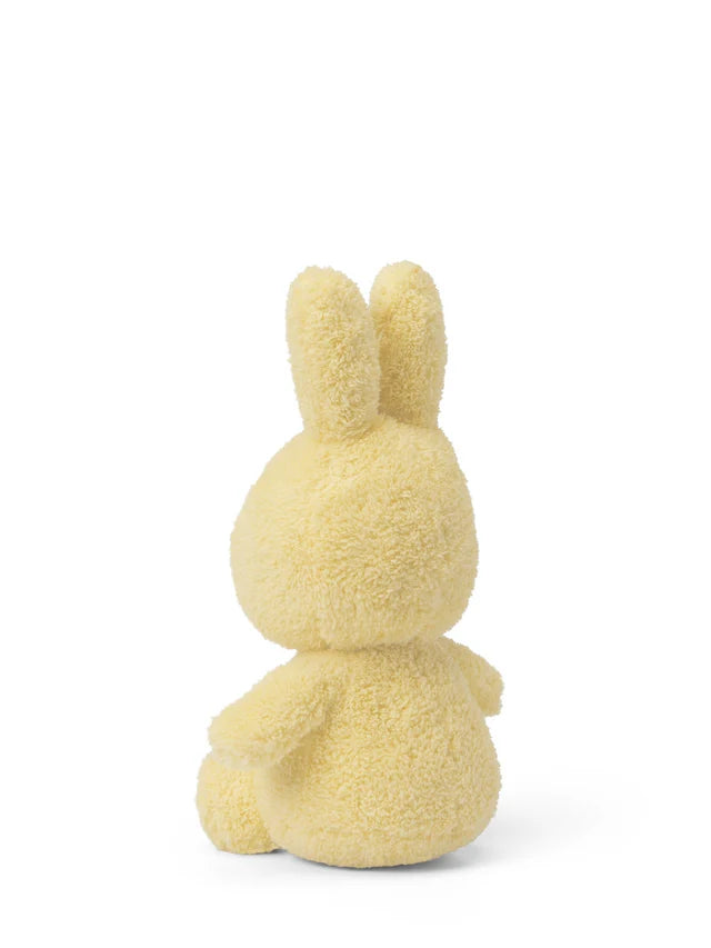 Yellow plush bunny toy on a white background