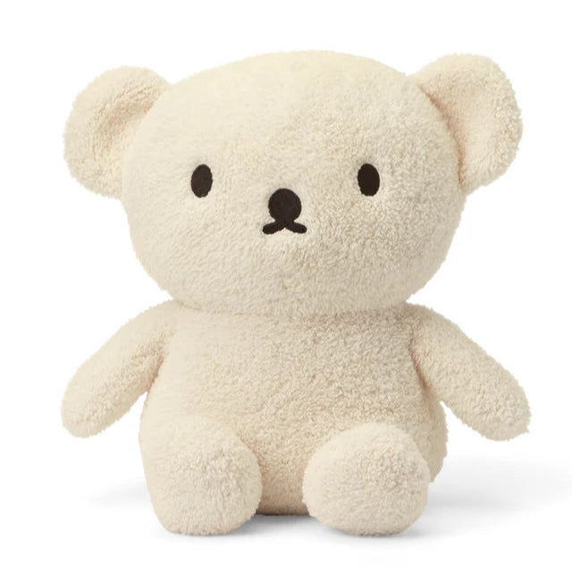 Cream-colored plush teddy bear with simple embroidered facial features.