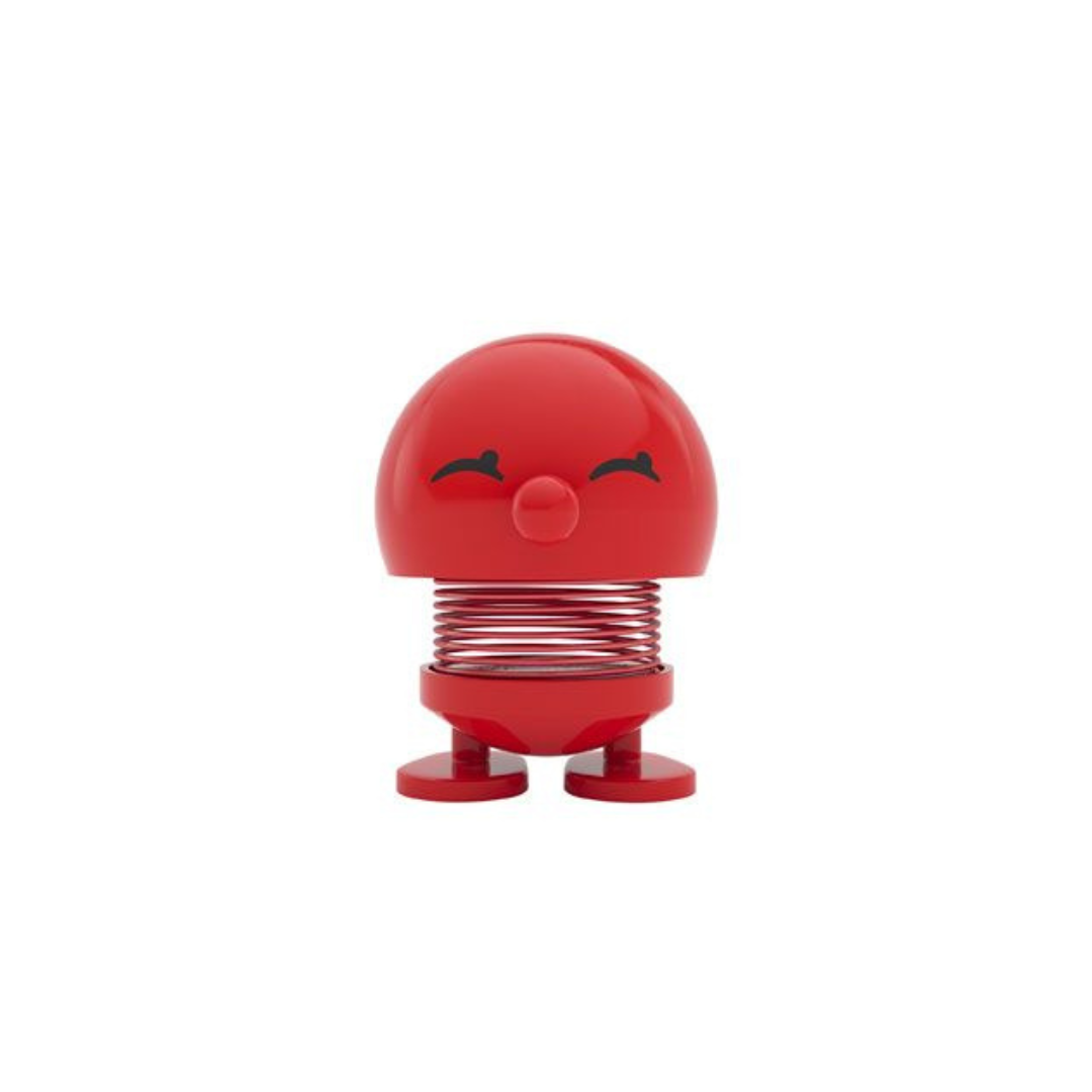 Red bobblehead toy with a smiling face, mounted on a spring.