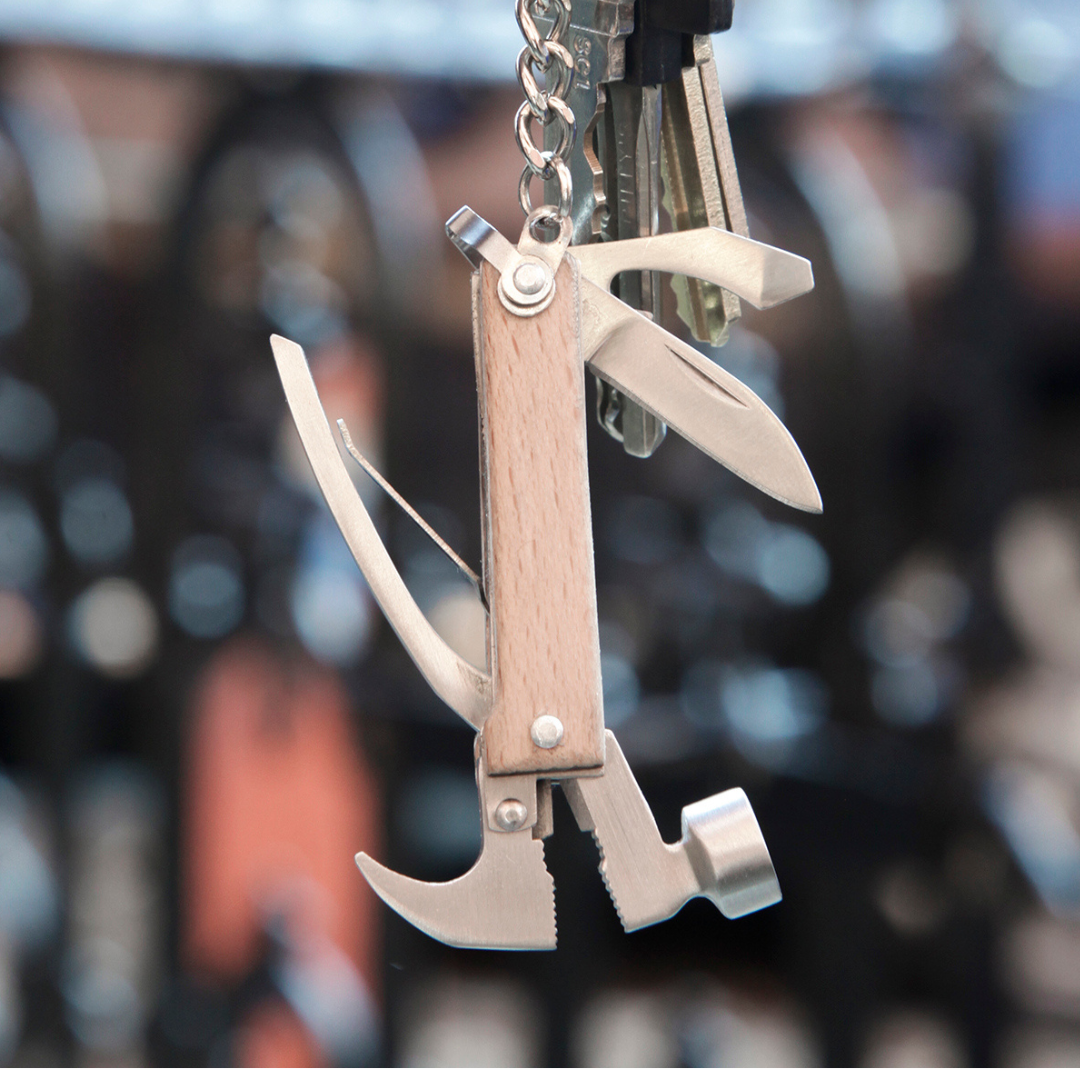 Multi-tool keychain with hammer, knife, and bottle opener. Wooden handle.