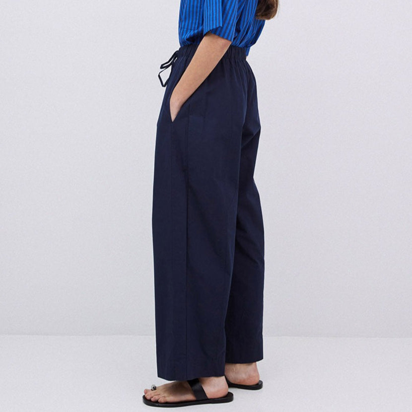 Navy blue wide-leg pull-on pants with drawstring waist.