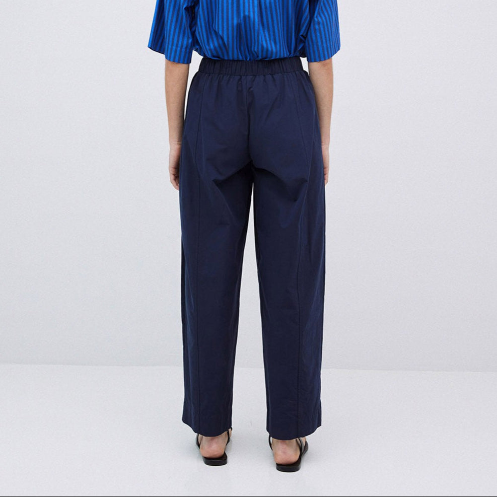 Navy blue wide-leg pull-on pants with center creases.