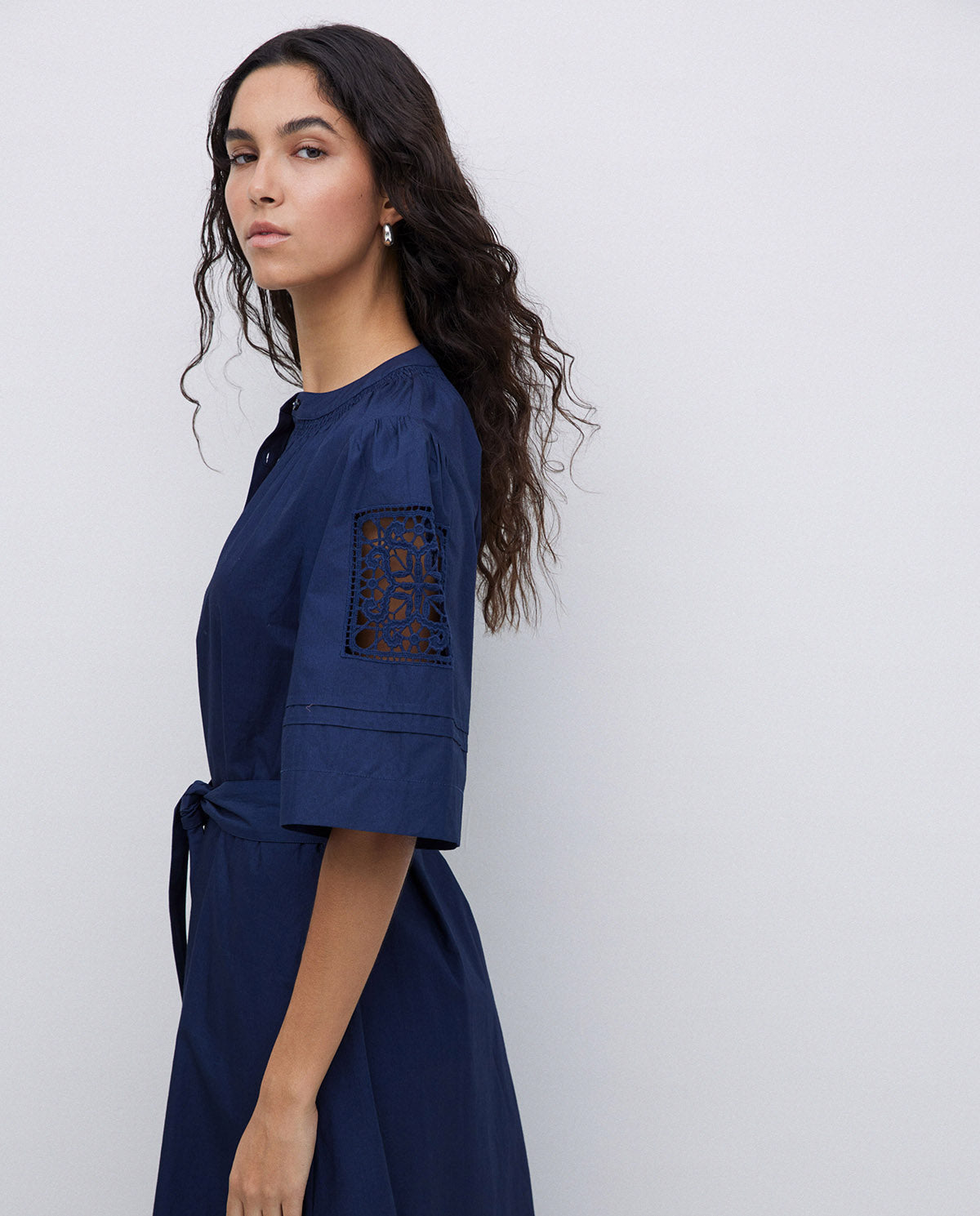 Navy blue midi dress with elbow-length sleeves and lace inserts. Belted waist.