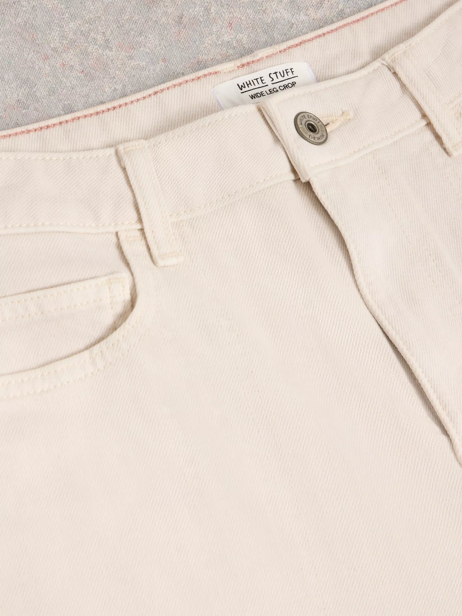 Cream-colored White Stuff wide-leg crop jeans; waistband detail, button closure, and front pocket visible.