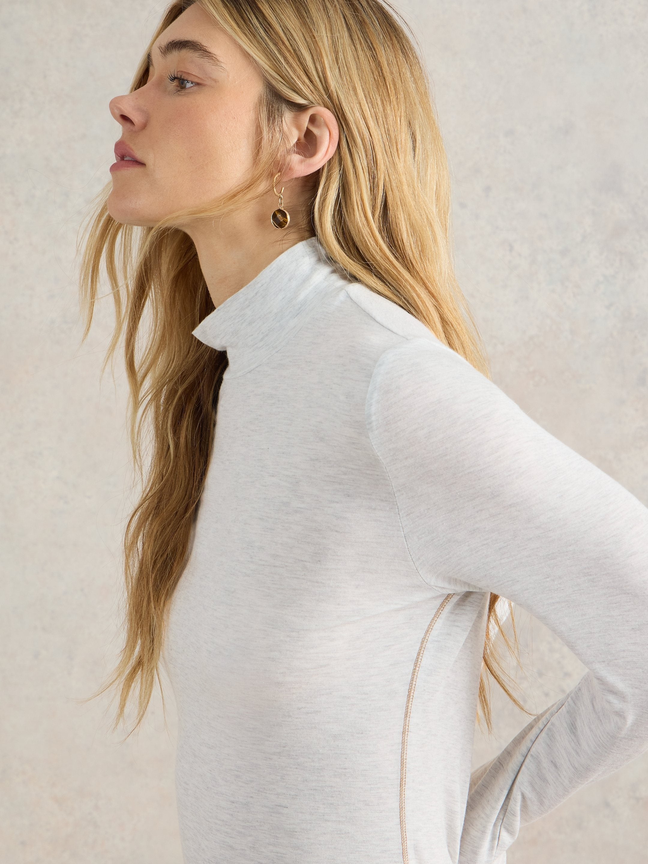 Light gray heather long-sleeve mock neck shirt with subtle side seam detail.