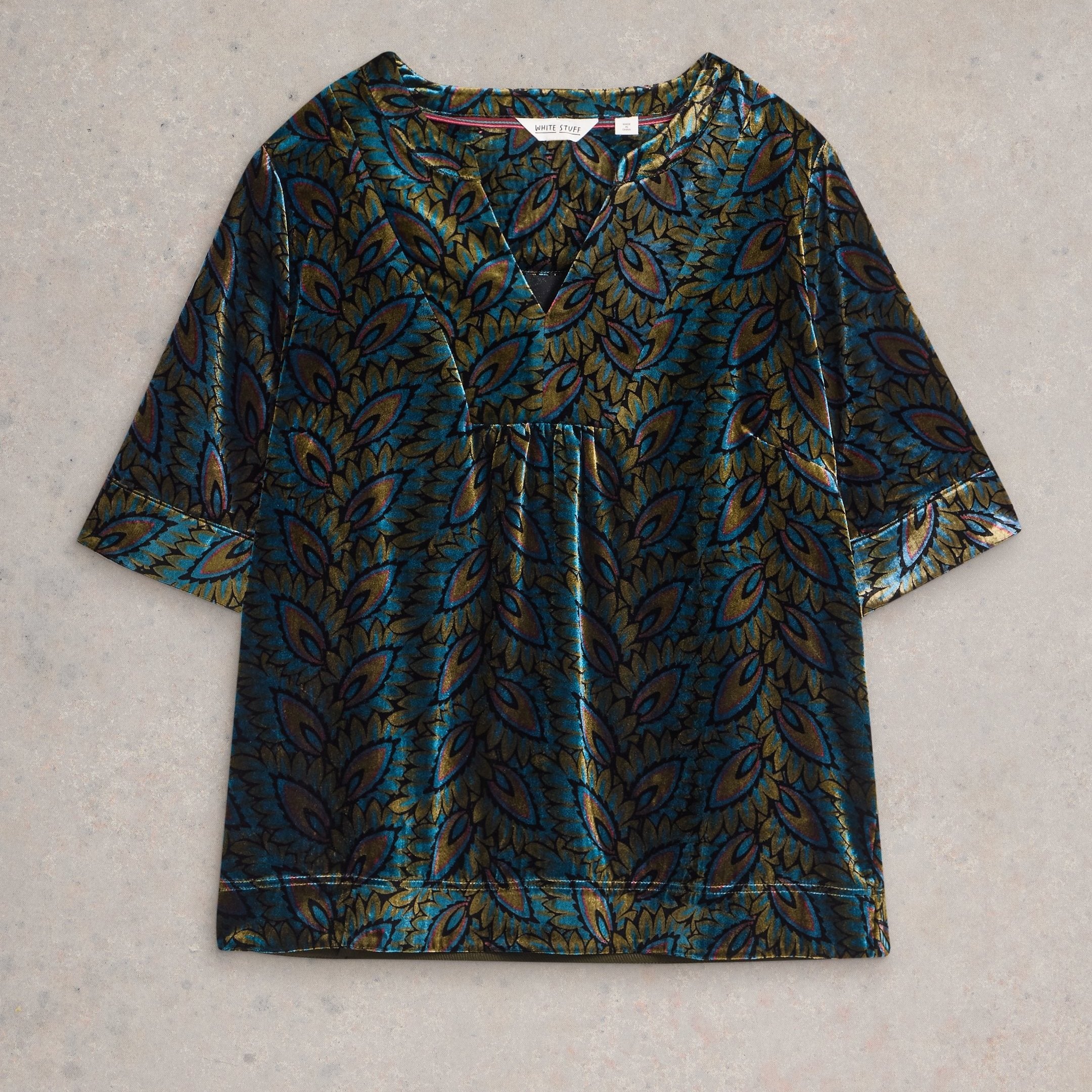 Teal velvet top with a V-neck and short sleeves, featuring a gold and teal leaf pattern.