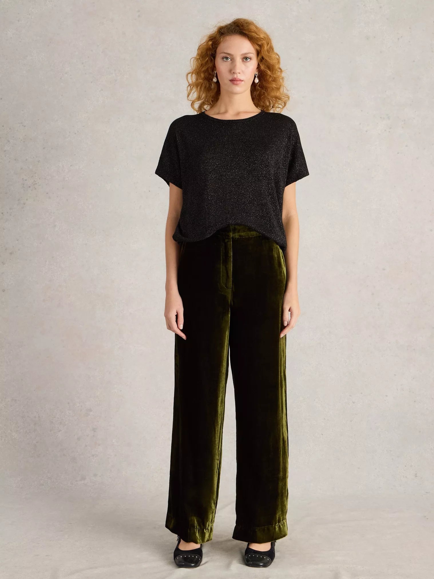 Olive green velvet wide-leg pants; high-waisted with a straight leg.