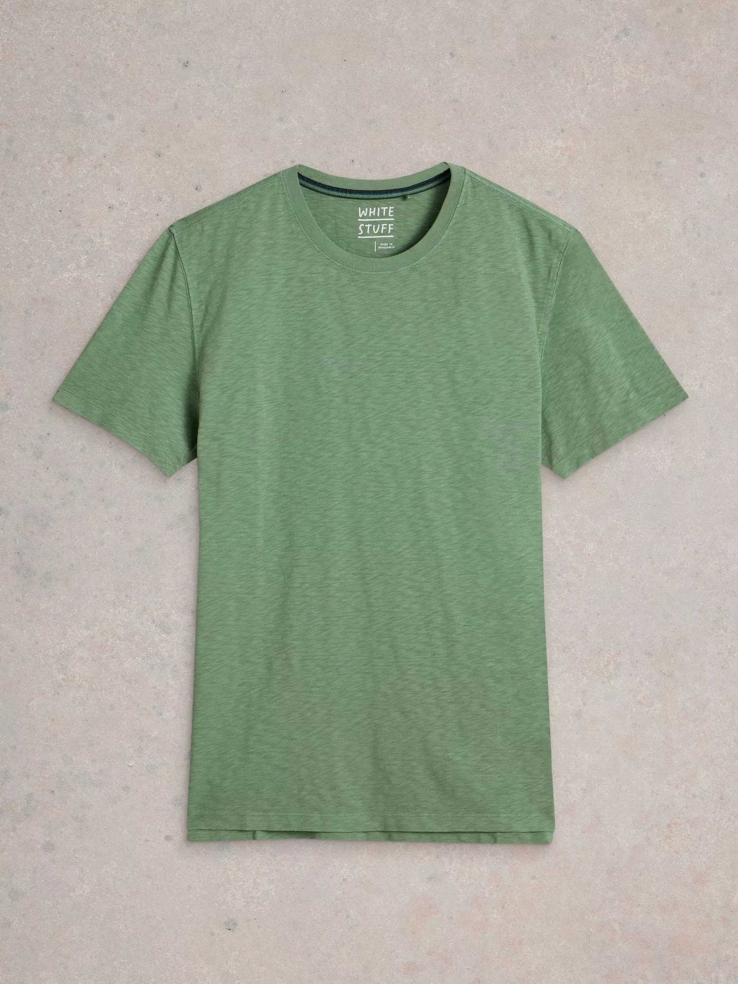 Sage green short-sleeve crew neck t-shirt, featuring a subtle textured fabric and "White Stuff" branding on the neck label.
