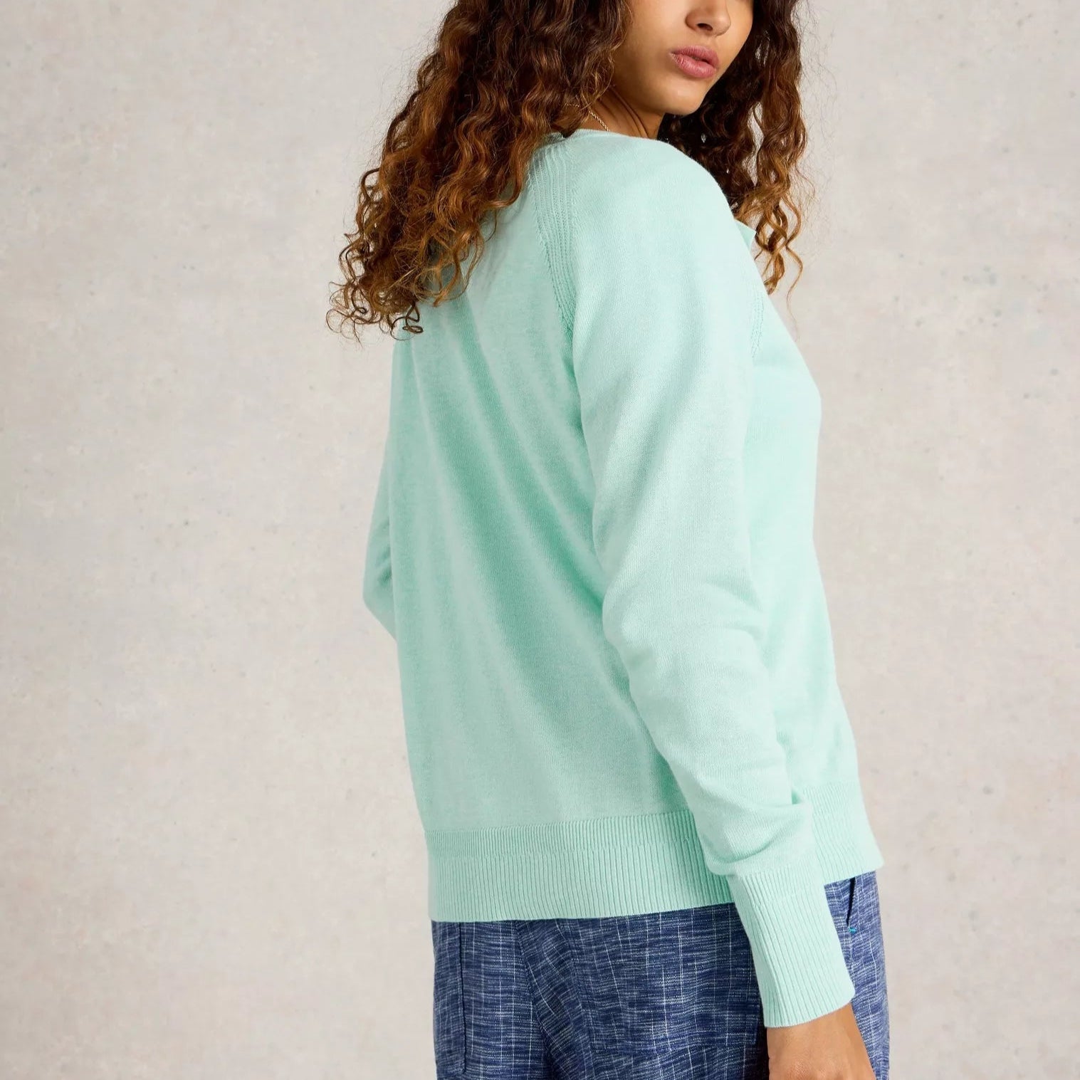 Mint green long-sleeved crewneck sweater with ribbed cuffs and hem.