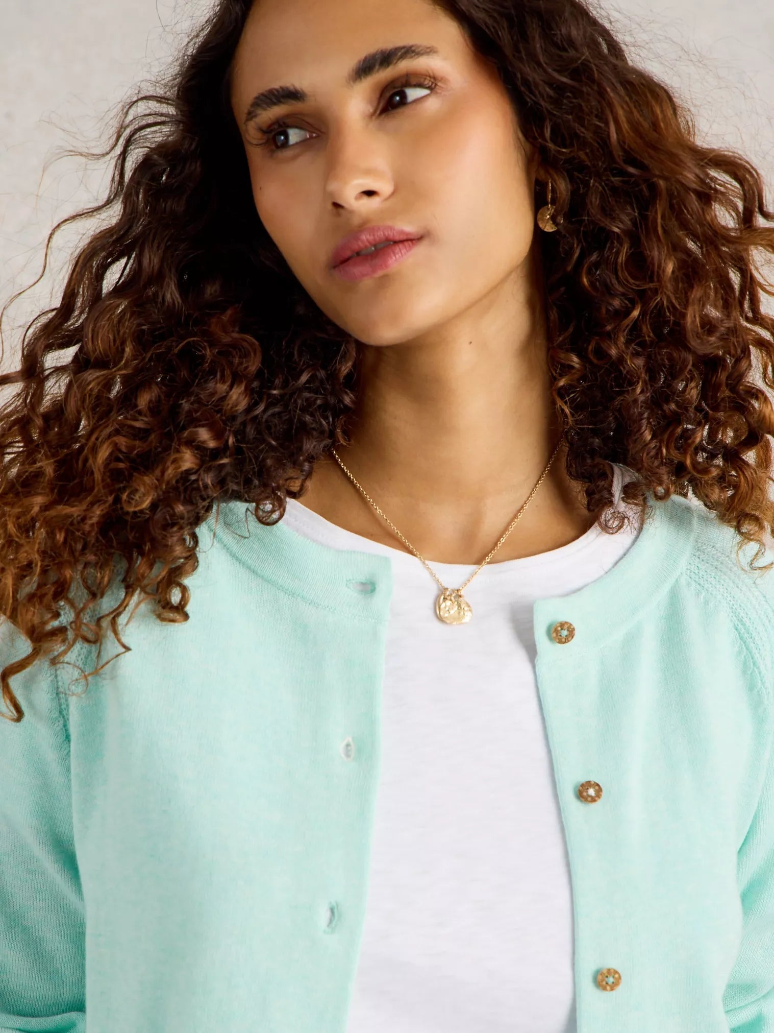 Mint green cardigan sweater with wooden buttons.
