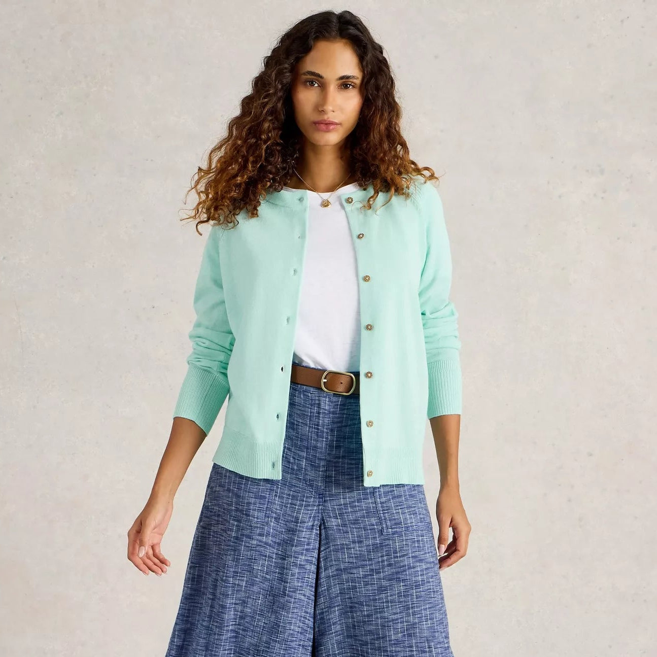Mint green button-front cardigan sweater with ribbed cuffs and hem.