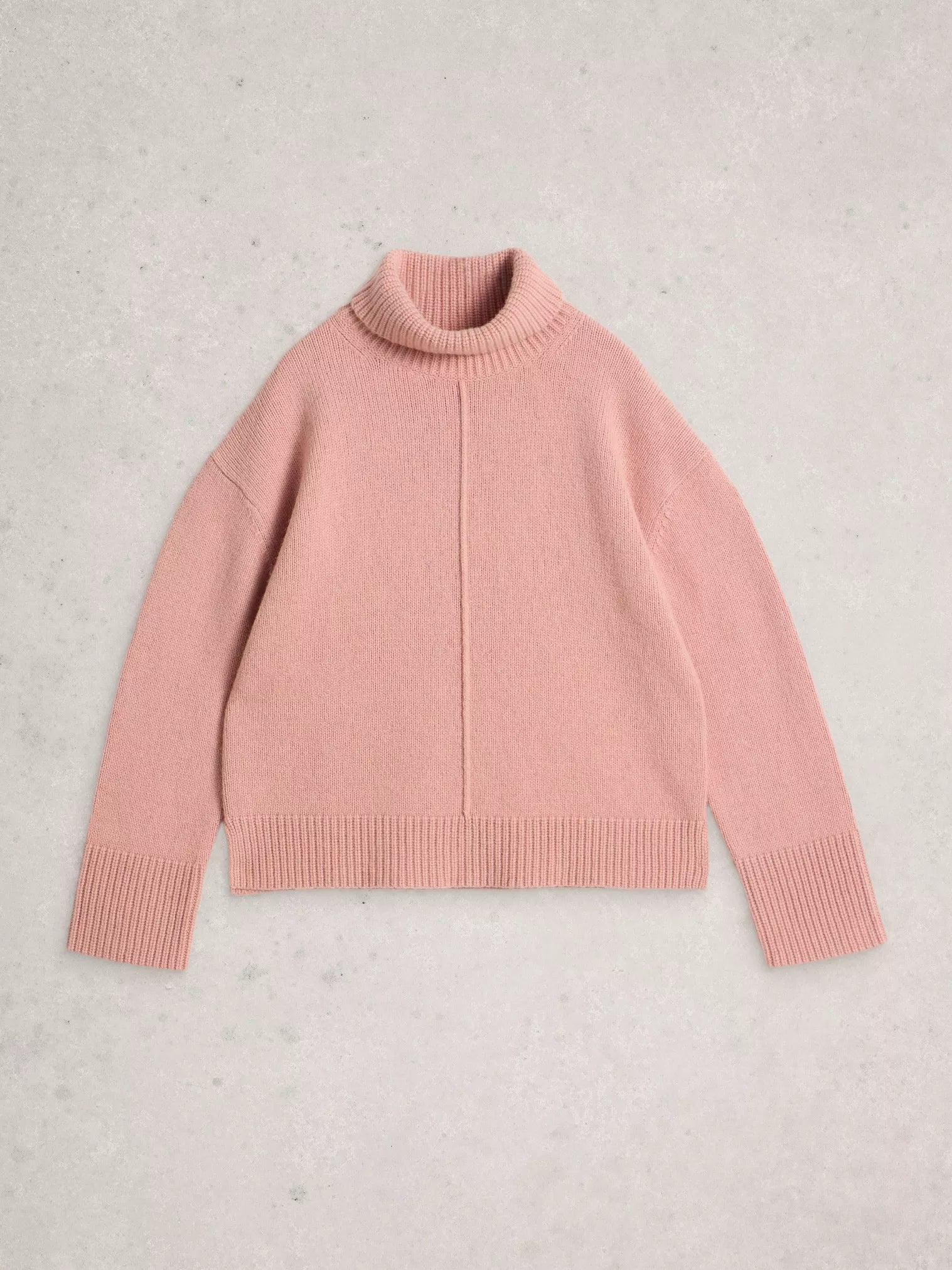 Pink sweater on a light gray background