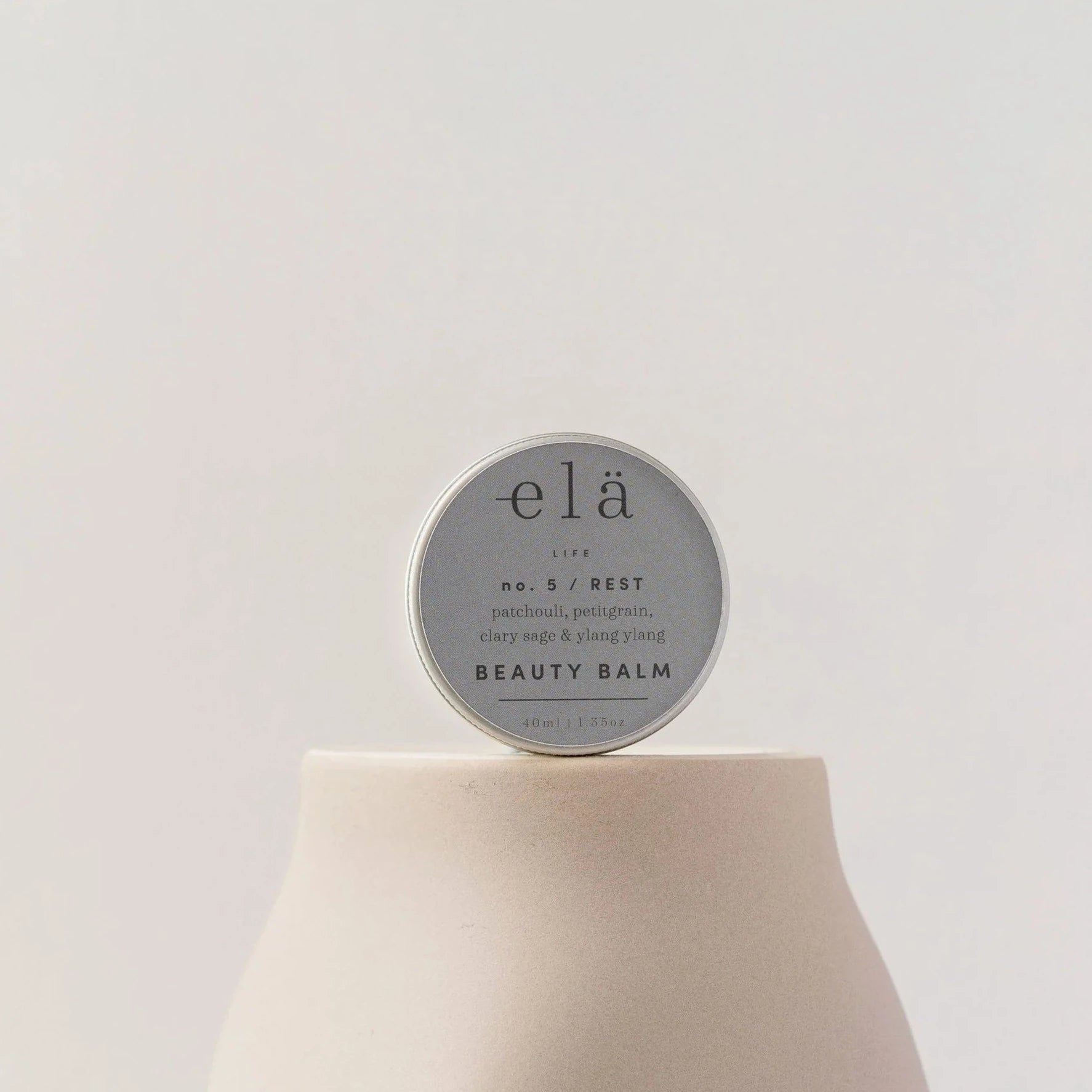 elä LIFE No. 5 REST Beauty Balm in a silver tin.  Contains patchouli, petitgrain, clary sage & ylang ylang. 40ml/1.35oz.