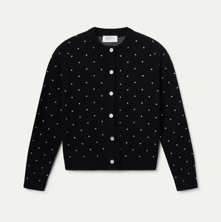 Black cardigan with white button details on a light gray background