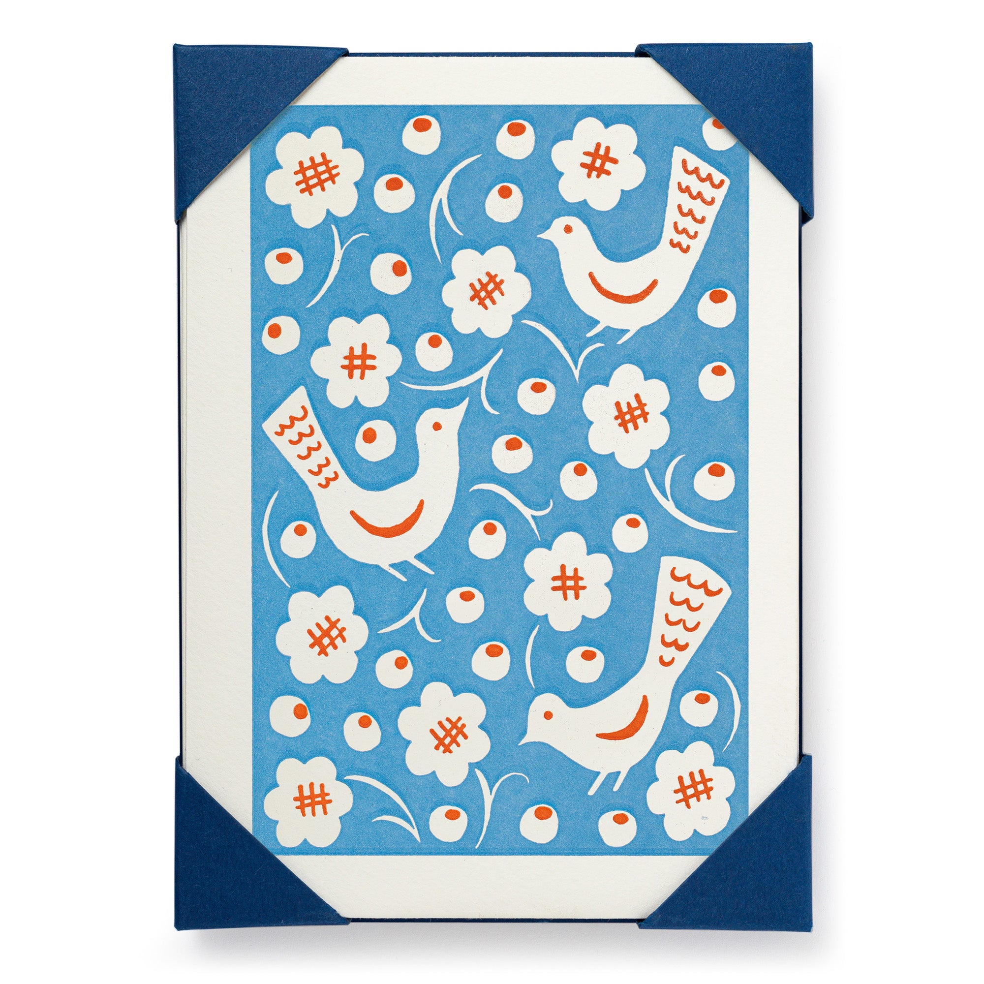 Notecard featuring a blue background with stylized white birds, orange accents, and simple white flowers.