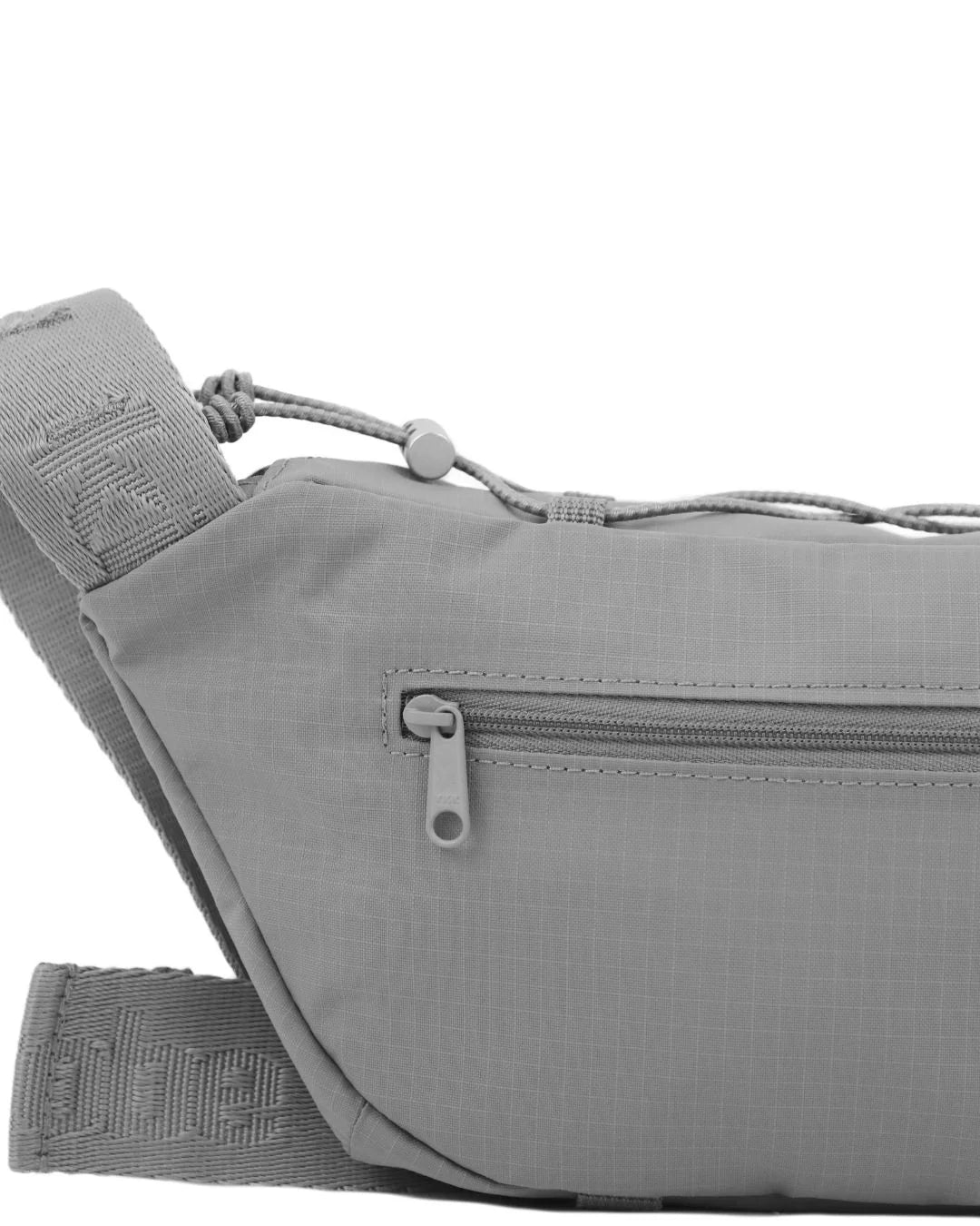 Gray fabric fanny pack with adjustable strap and zippered pocket.