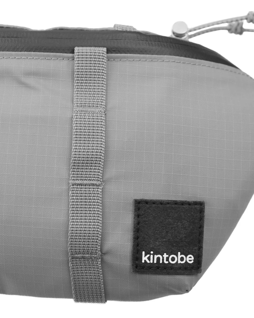Gray Kintobe zippered pouch with gray straps and a small black logo patch.