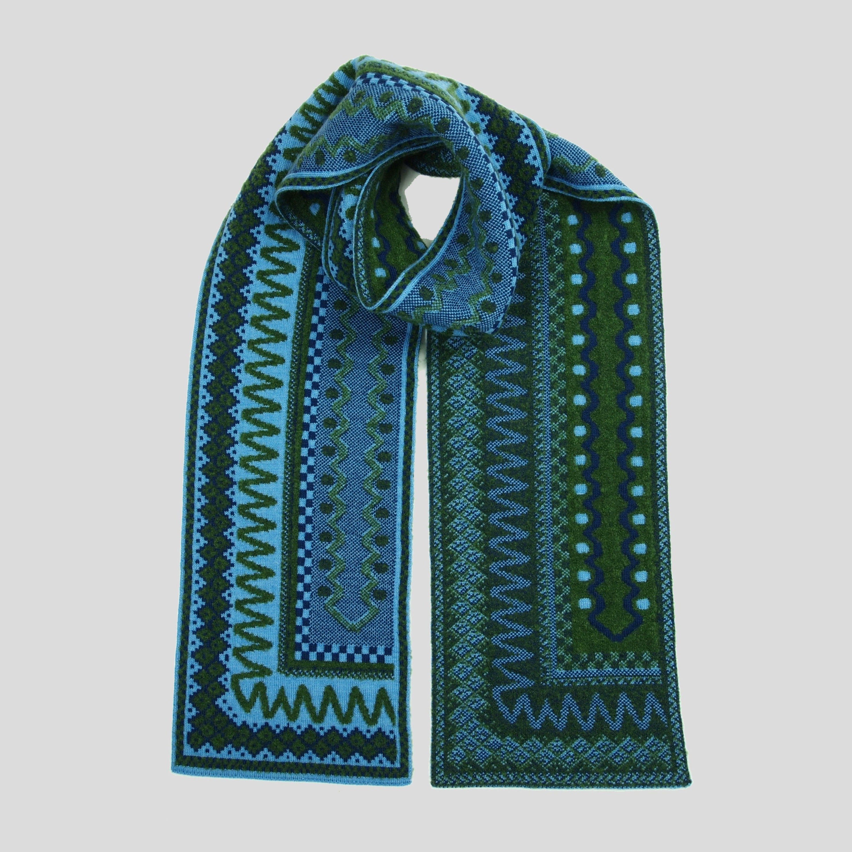 Knit wool scarf in teal and forest green with an intricate geometric pattern.