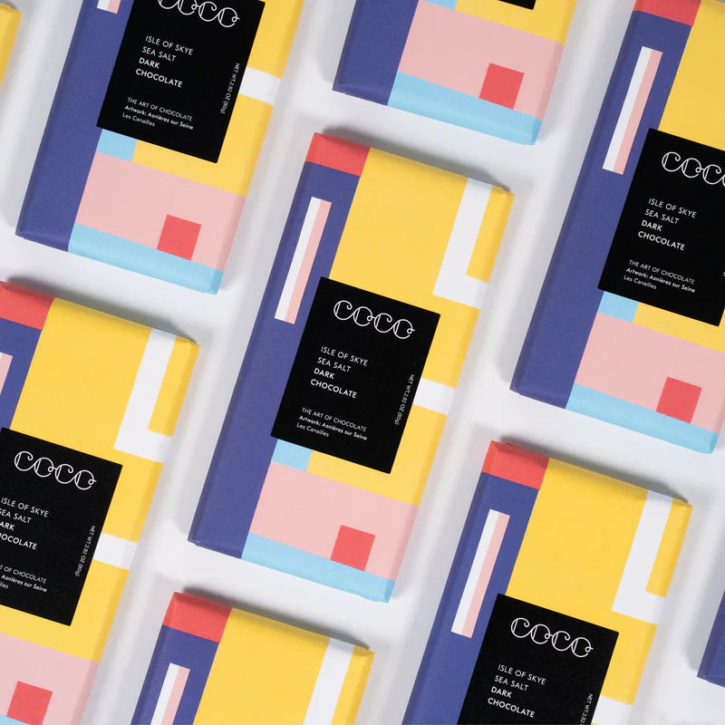 Multiple bars of Isle of Skye Sea Salt Dark Chocolate, packaged in yellow, purple, pink, and light blue geometric design.