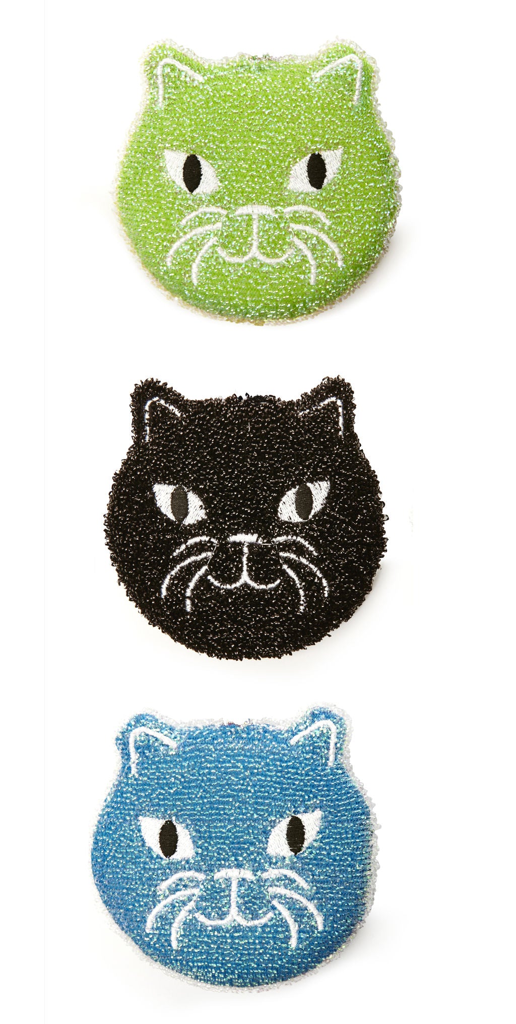 Three textured cat-shaped scrubbers in green, black, and blue. Each features embroidered eyes and whiskers.