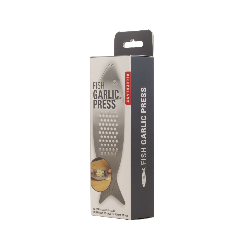 Stainless steel fish-shaped garlic press in its retail packaging.