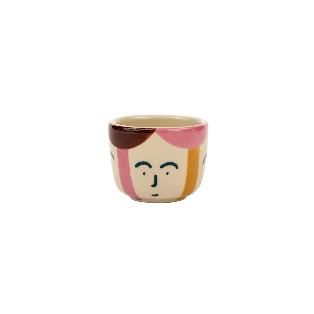 Ceramic mug with a face design on a white background