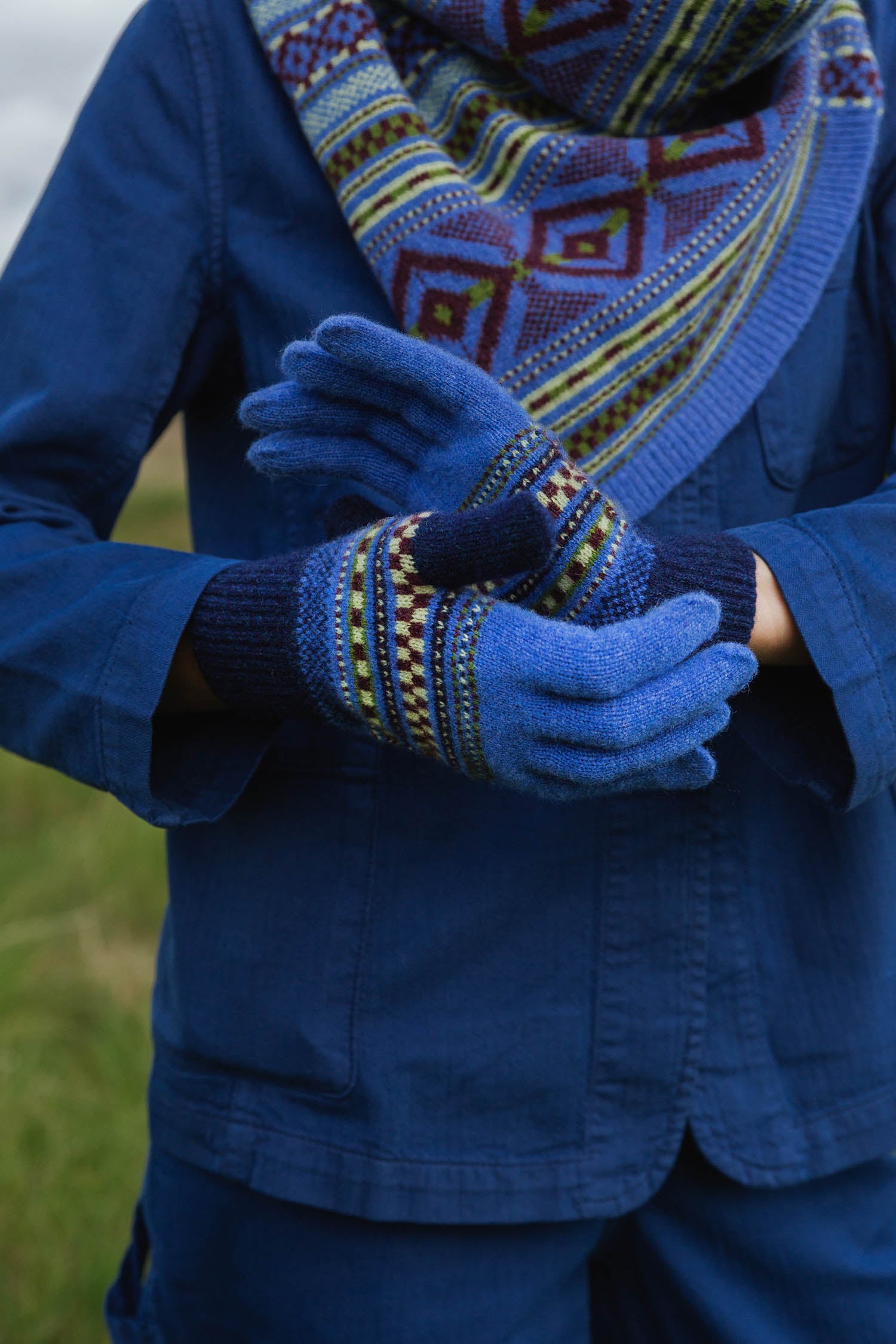 Pair of blue wool gloves with multicolored Fair Isle-style cuffs.