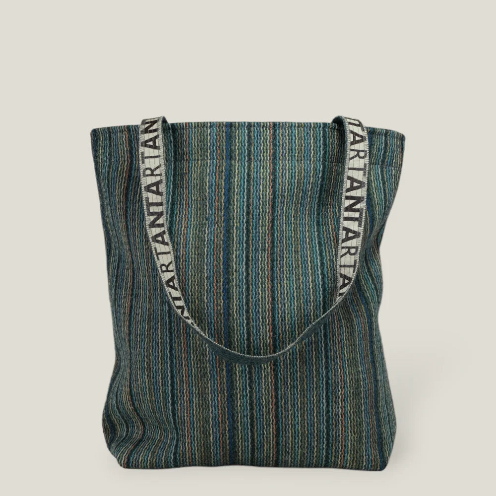 Multicolored striped tote bag with "ARTANTARTAN" branded straps.