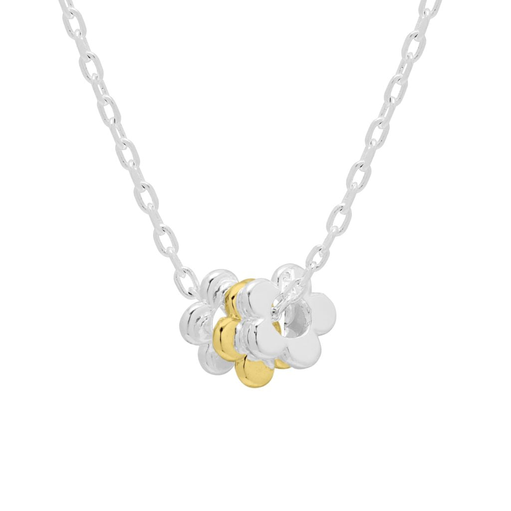 Silver chain necklace with a double flower pendant; one flower is silver, the other gold.