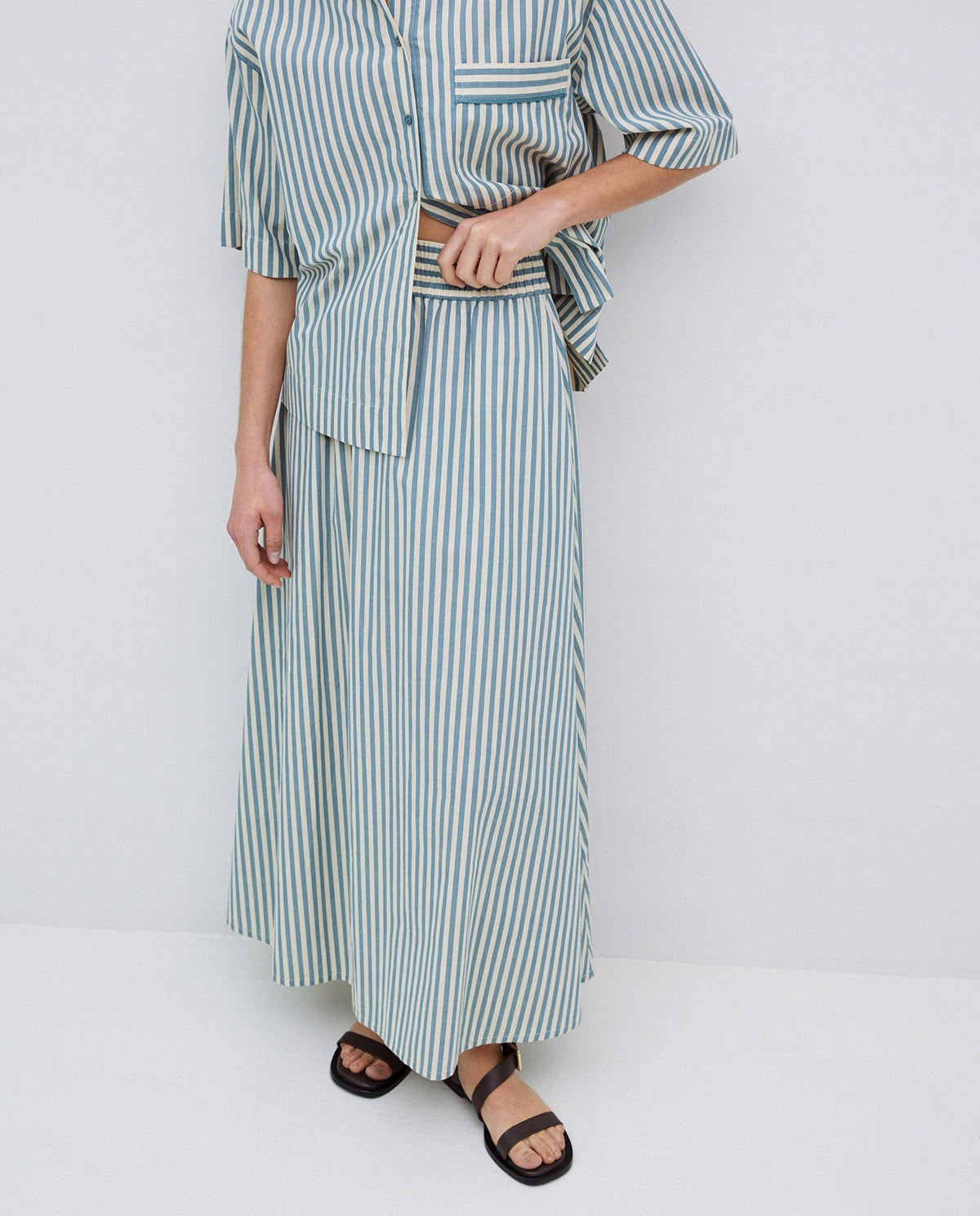 Blue and white striped midi skirt with an elastic waistband.  Part of a matching shirt set.