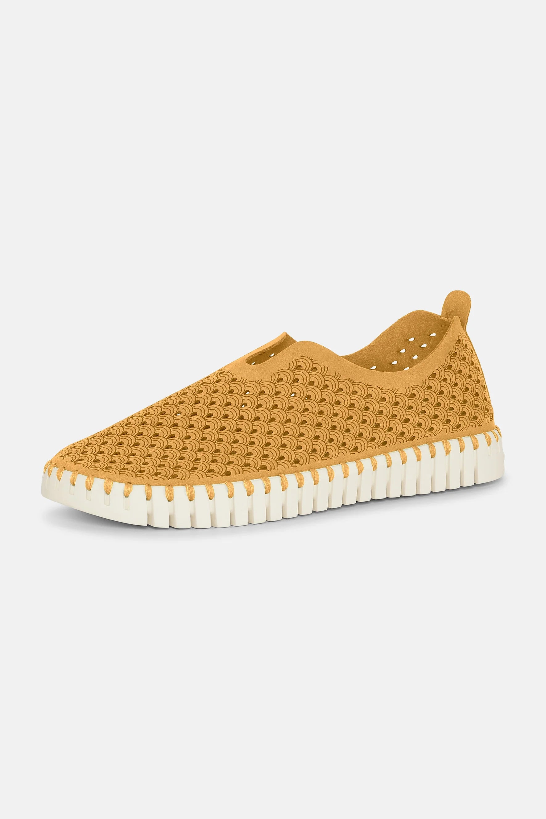 Mustard yellow slip-on shoe with a textured, wave-like pattern and a white, ridged sole.