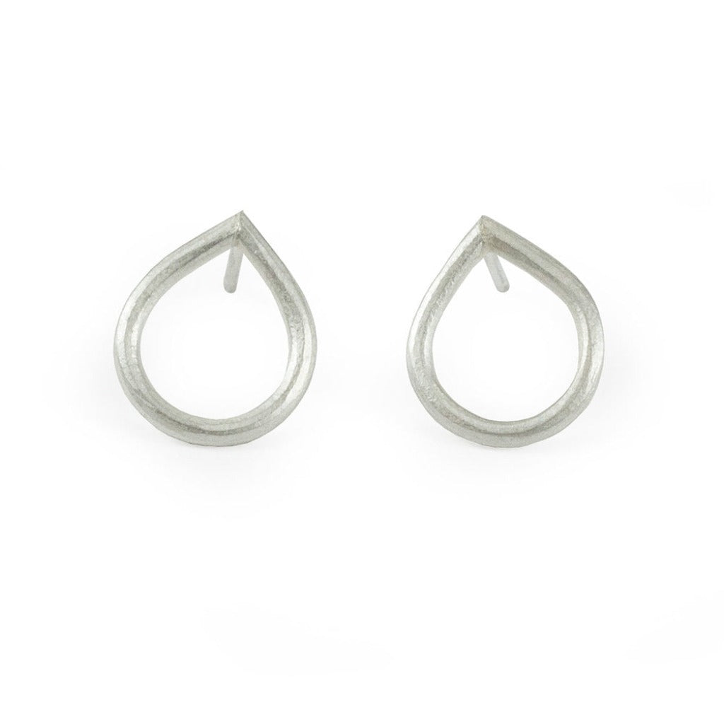 Pair of silver teardrop-shaped stud earrings with a matte finish and open circular design.