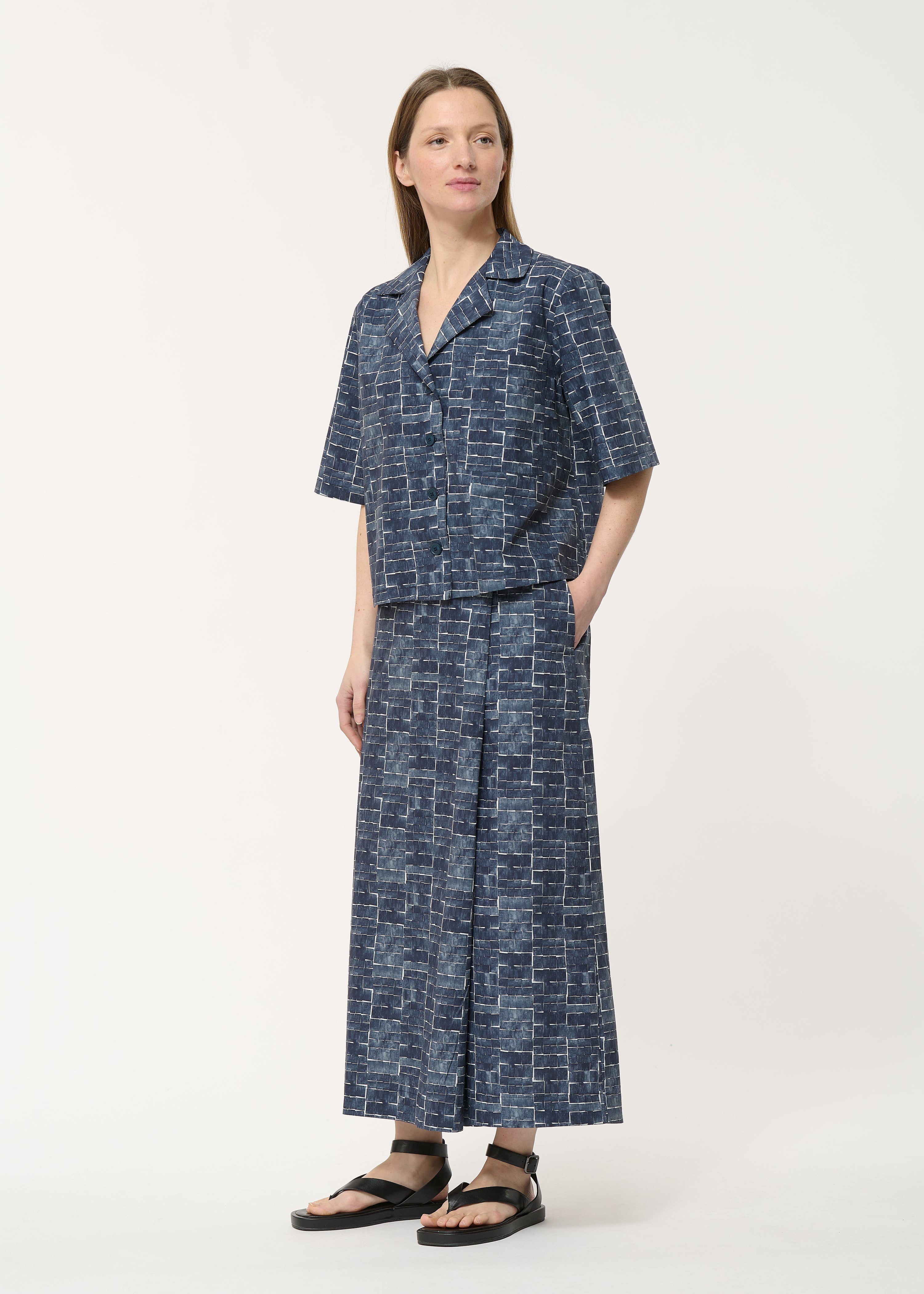 Navy blue women's short-sleeved collared shirt and matching wide-leg pants.