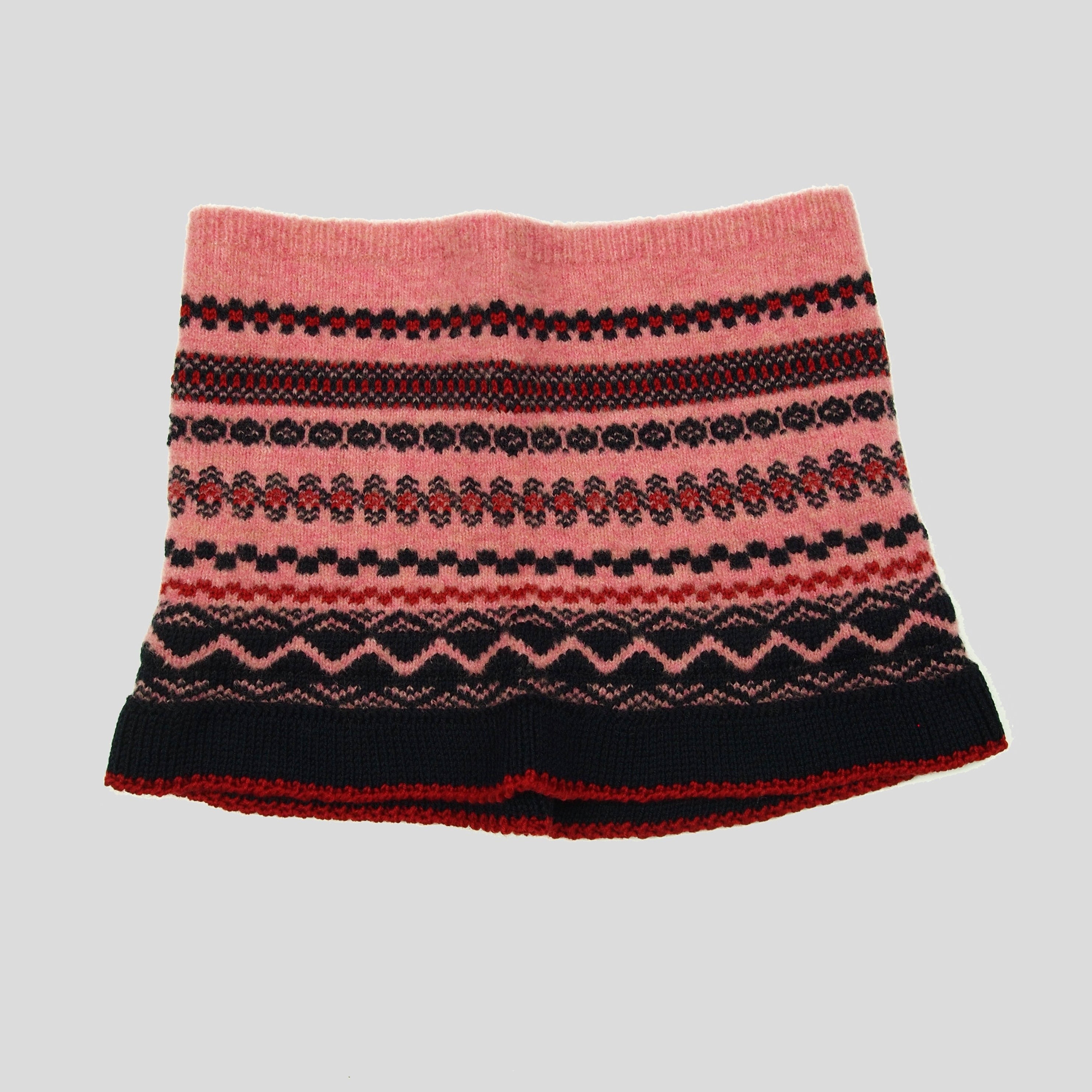 Pink knitted headband with a Fair Isle-style pattern in navy, red, and gray.