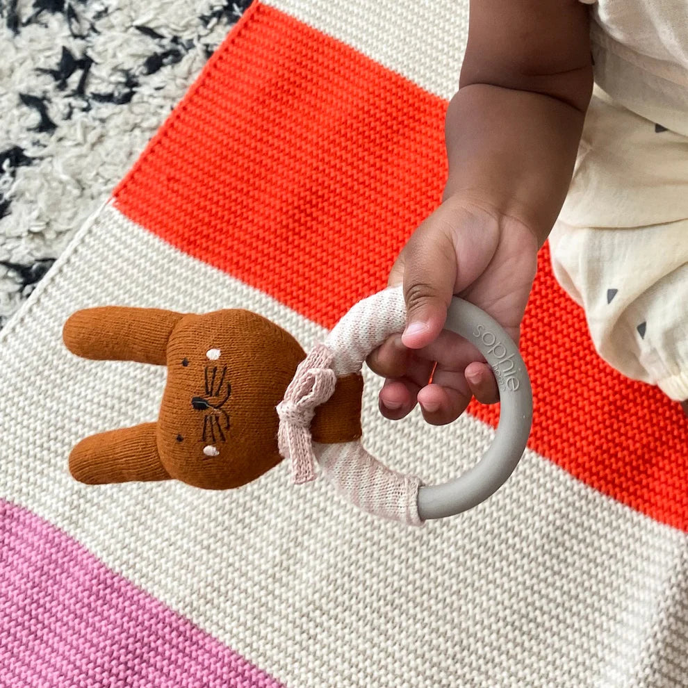 Baby's knitted bunny rattle with a grey silicone teething ring.