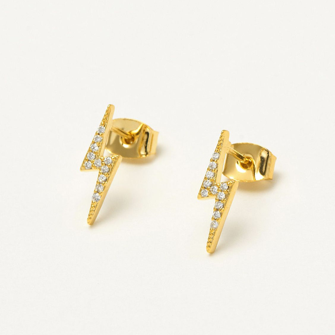 Gold lightning bolt stud earrings with clear cubic zirconia accents.