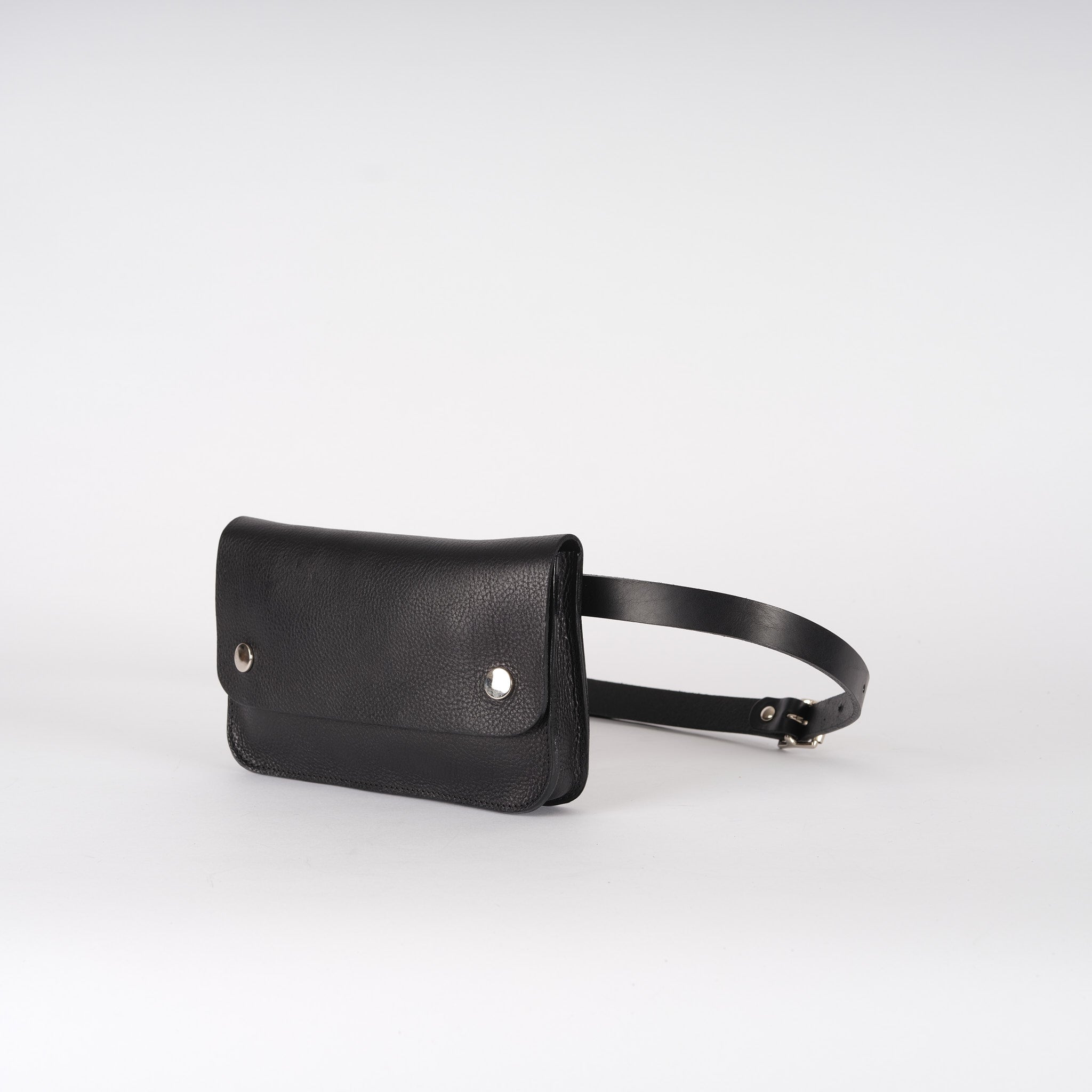 Black leather waist bag with a rectangular pouch and a simple buckle strap.