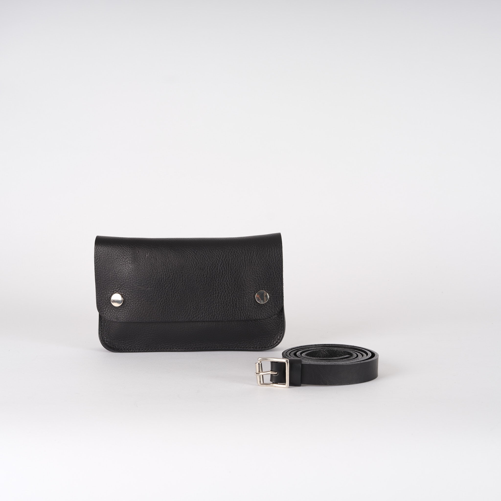 Black leather belt bag with a rectangular pouch and a simple silver buckle.