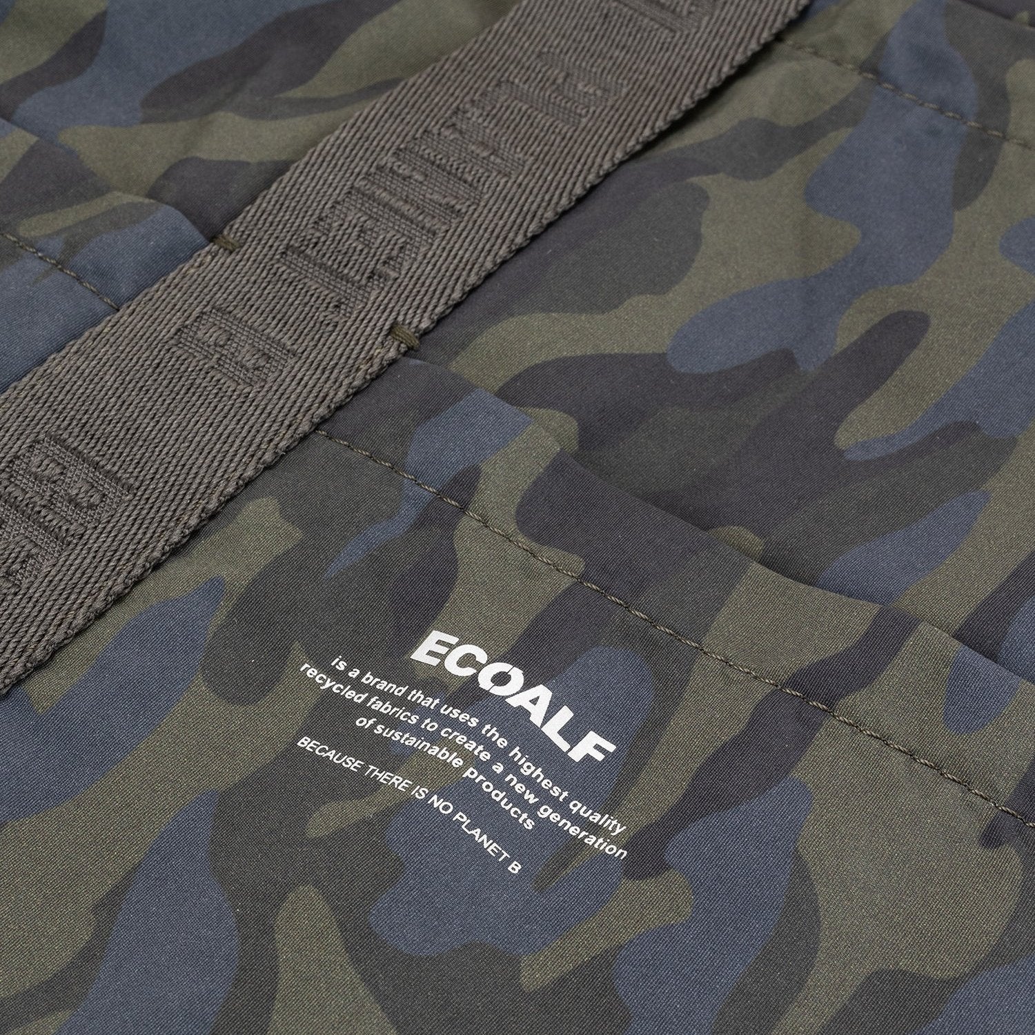 Close-up of a camouflage-patterned bag with a gray strap and the ECOALF logo.